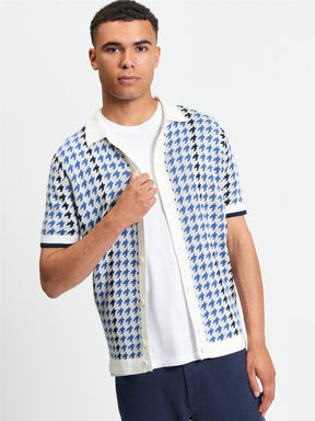 Ben Sherman Houndstooth Button Through Polo in Ivory - man wearing knitted polo with blue and ivory houndstooth pattern and button-through placket