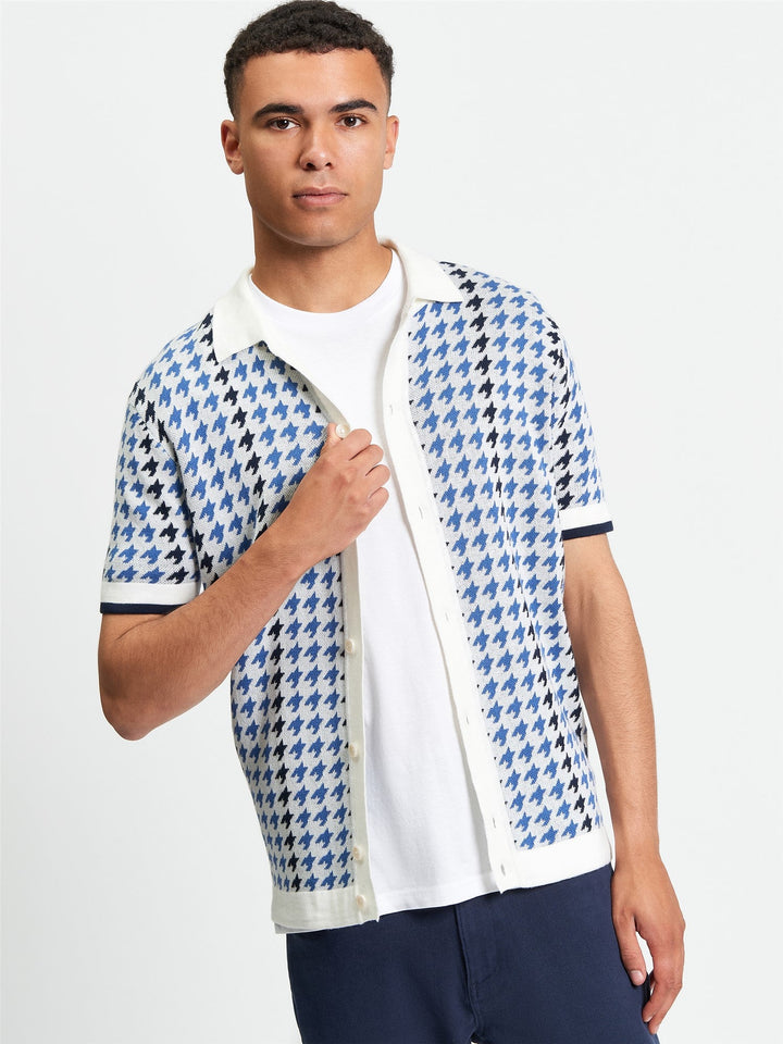Ben Sherman Houndstooth Button Through Polo in Ivory - man wearing knitted polo with blue and ivory houndstooth pattern and button-through placket