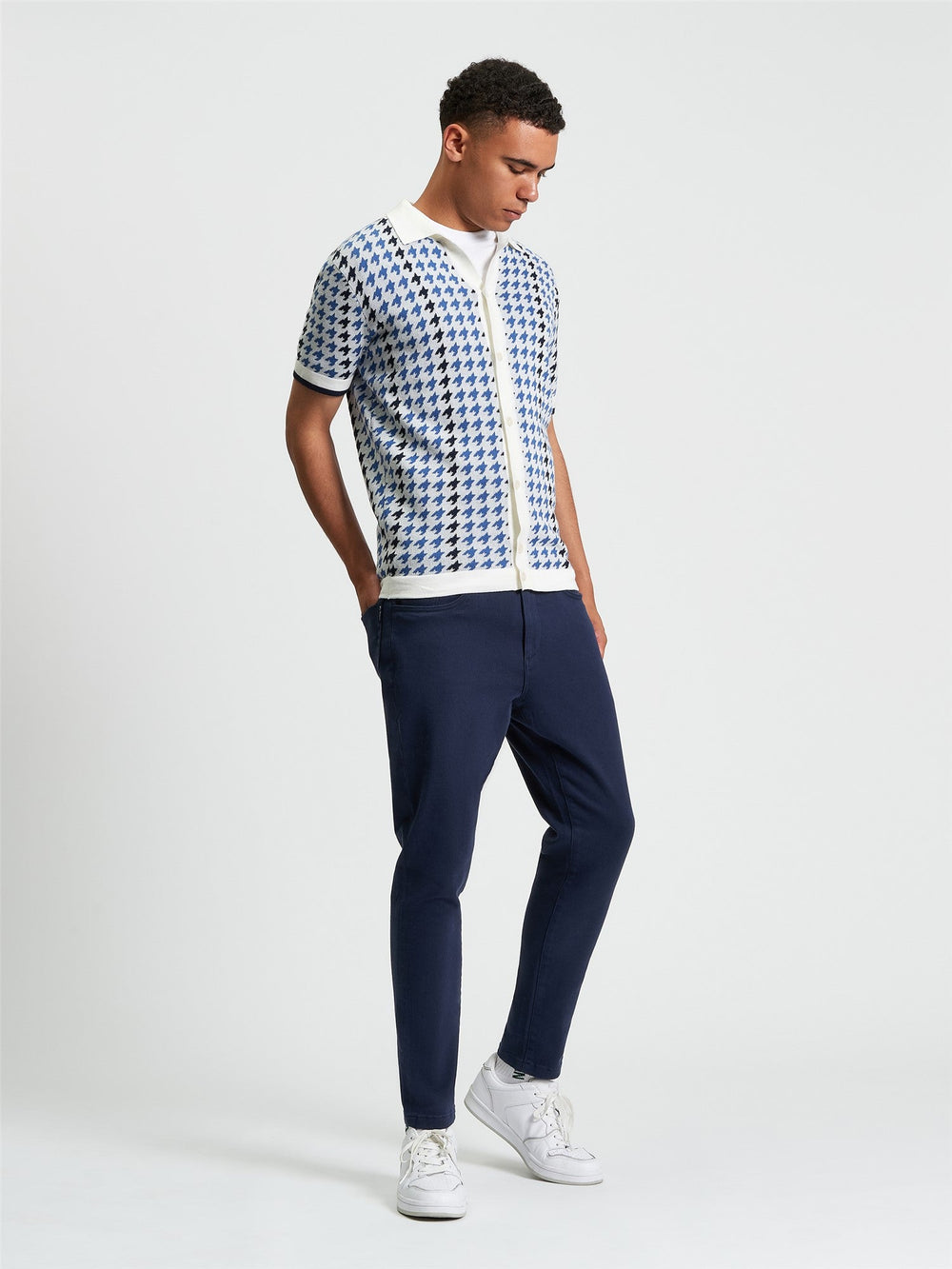 Ben Sherman Houndstooth Button Through Polo in Ivory - full body view of men's knitted polo with all-over ivory and navy houndstooth pattern styled with navy trousers