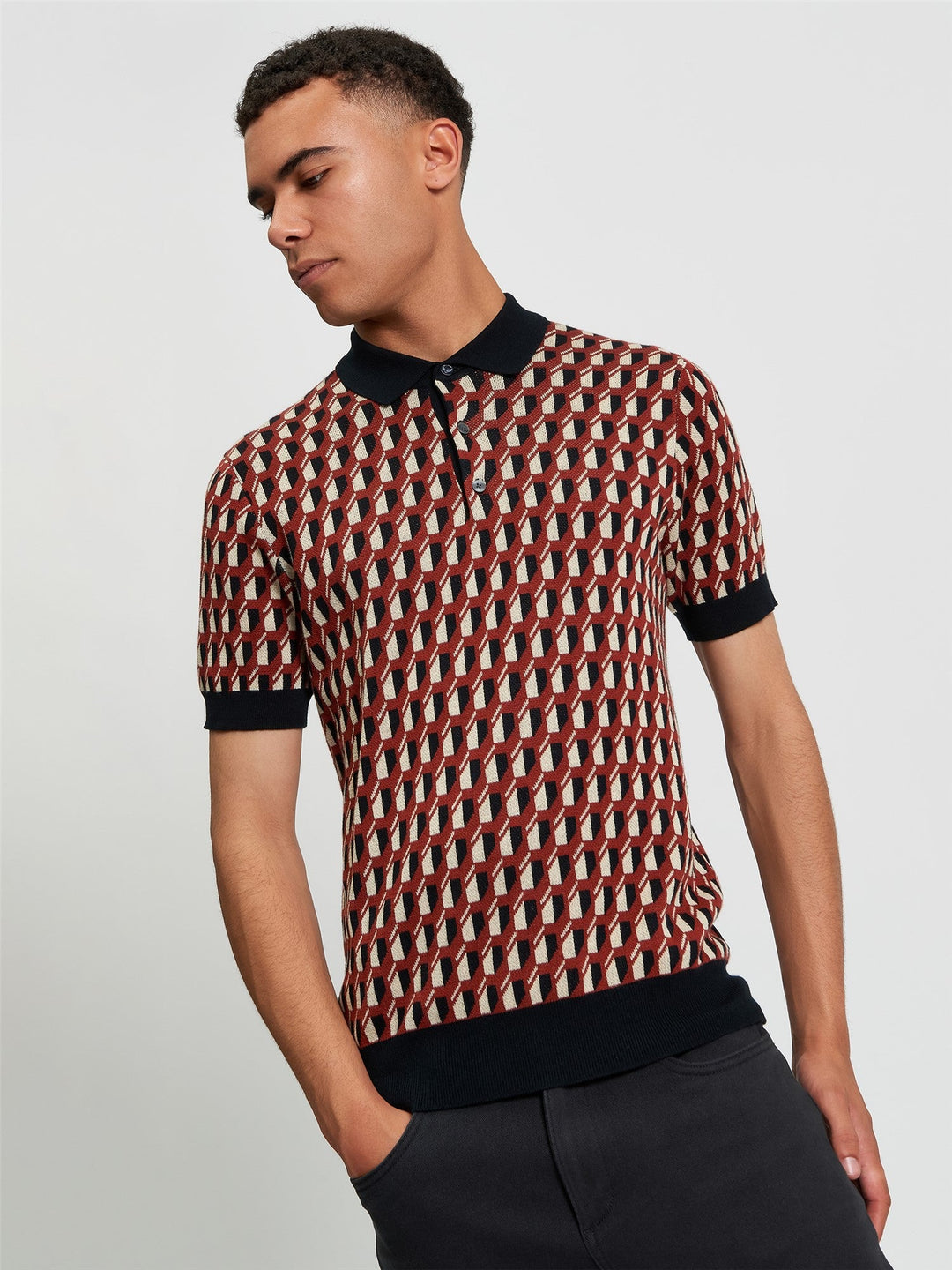 Ben Sherman All Over Jacquard Polo in Black - man wearing knitted polo with geometric all-over jacquard pattern and contrast black collar and cuffs