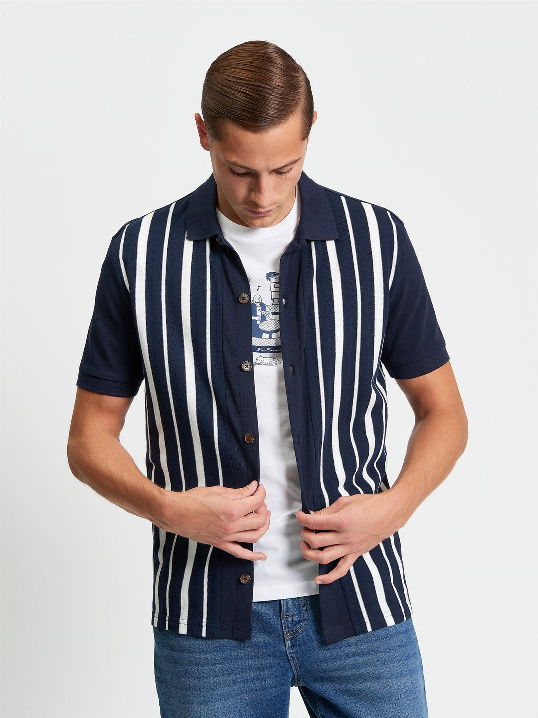 Ben Sherman Button Through Stripe Polo in Dark Navy - model wearing front view showing pique stripe design with full button placket and white stripe detail