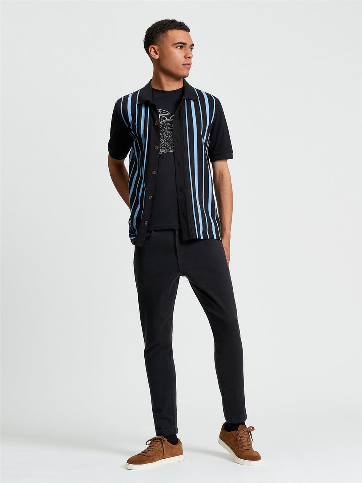 Ben Sherman Button Through Stripe Polo in Black - full length side view showing relaxed fit open button-through polo with blue stripe detail