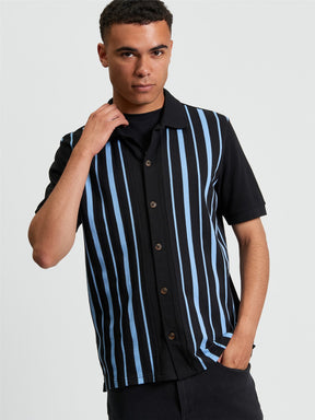 Ben Sherman Button Through Stripe Polo in Black - model wearing front view showing pique stripe design with full button placket