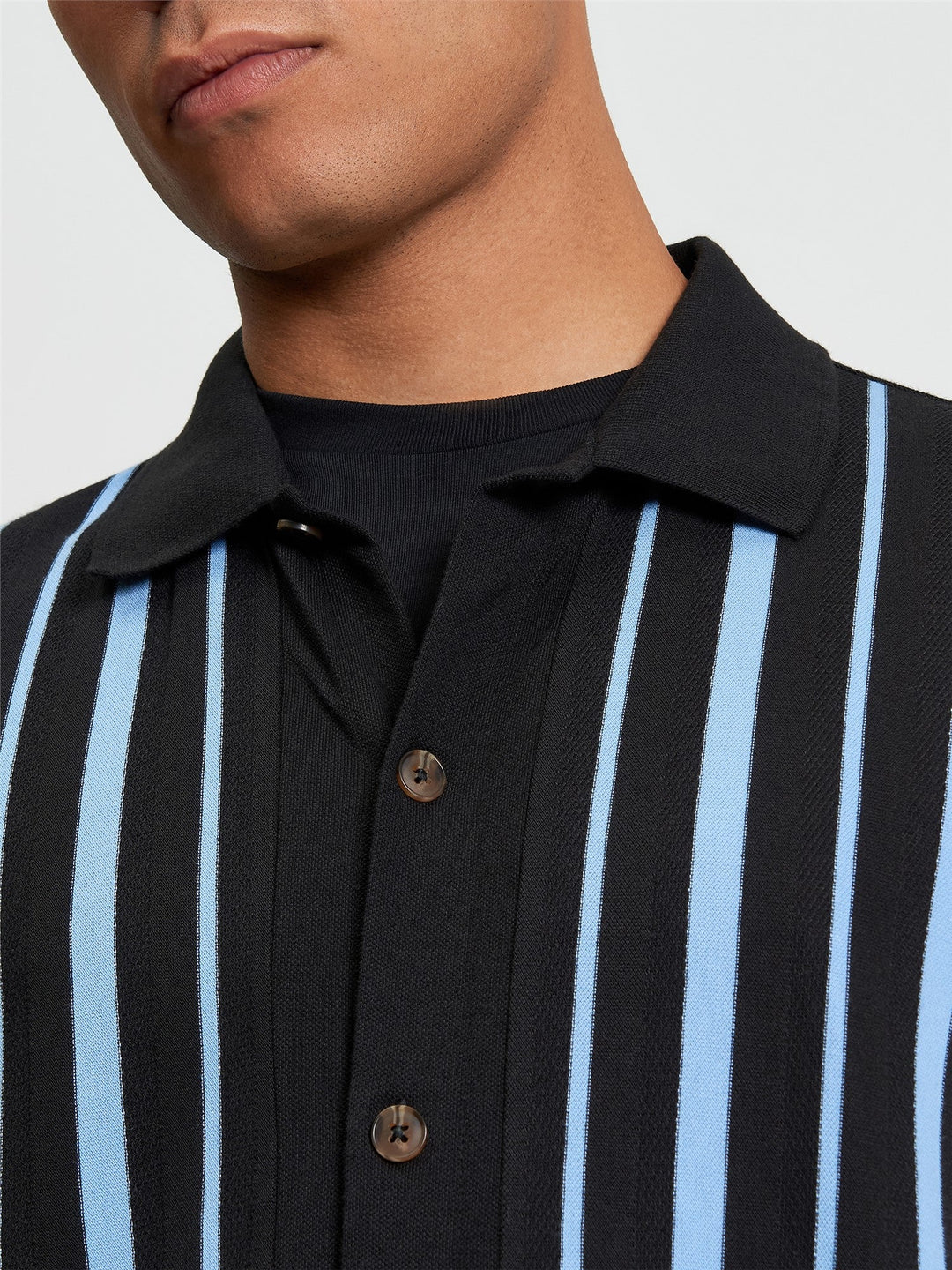 Ben Sherman Button Through Stripe Polo in Black - close-up detail of pique stripe texture with button-through placket and spread collar
