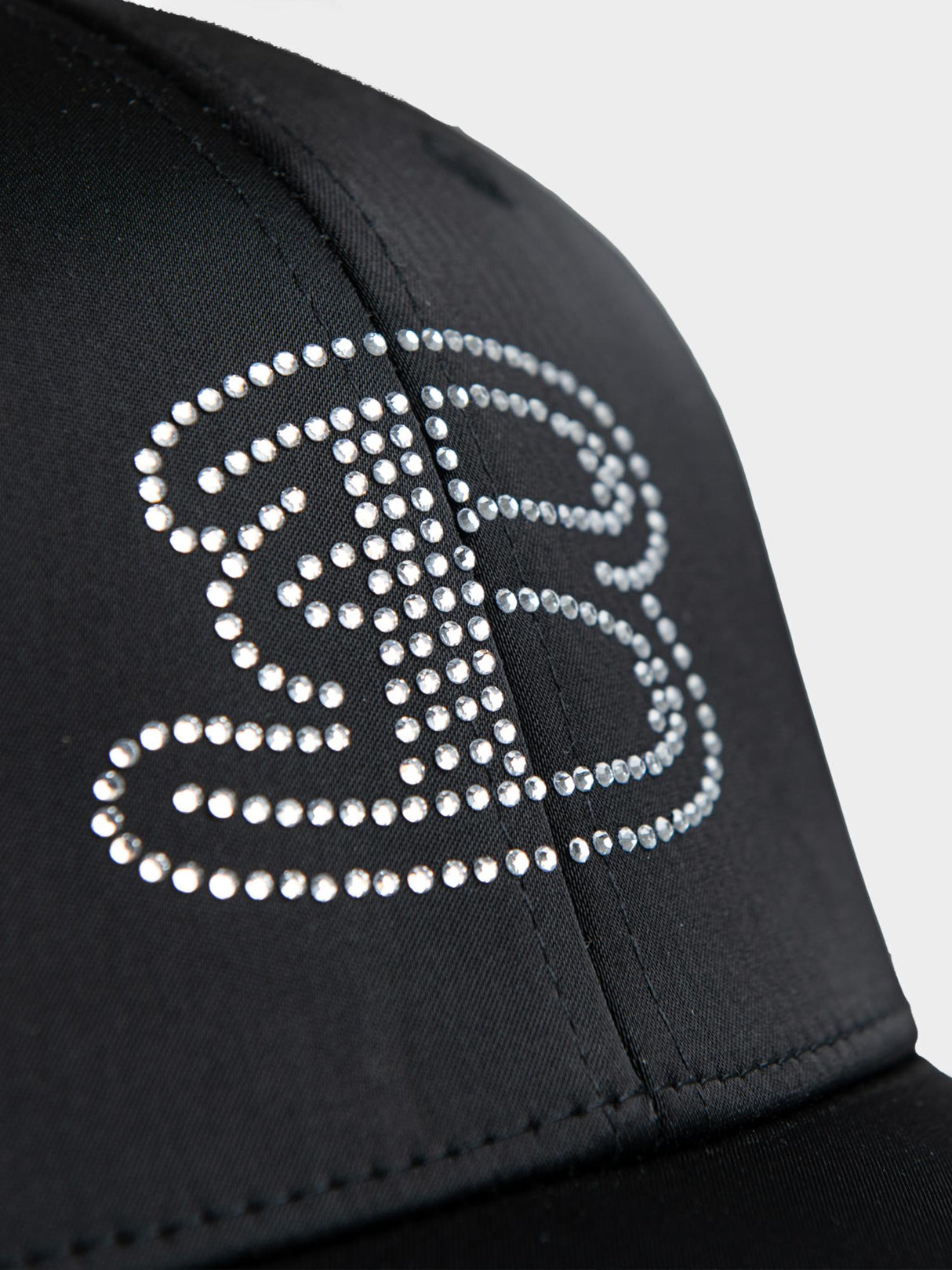 Ben Sherman B Bling Cap in Black - close-up of rhinestone 'B' logo embellishment on front panel