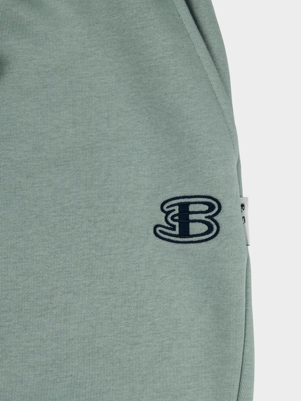 Close-up of embroidered Ben Sherman logo on agave green fleece jogger shorts - premium quality fabric detail