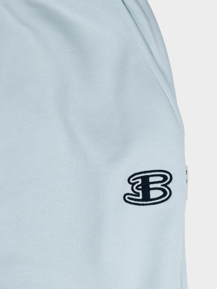 Close-up of embroidered Ben Sherman logo on light blue fleece jogger shorts - premium quality fabric detail