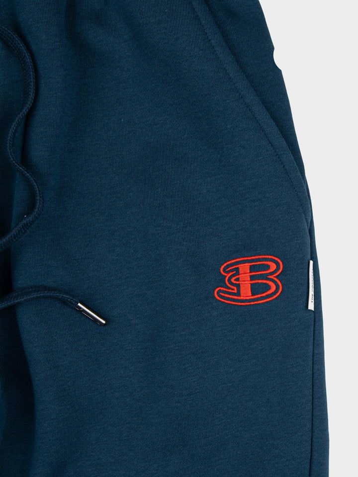 Close-up of embroidered Ben Sherman logo on indigo fleece jogger shorts - premium quality fabric and drawstring detail