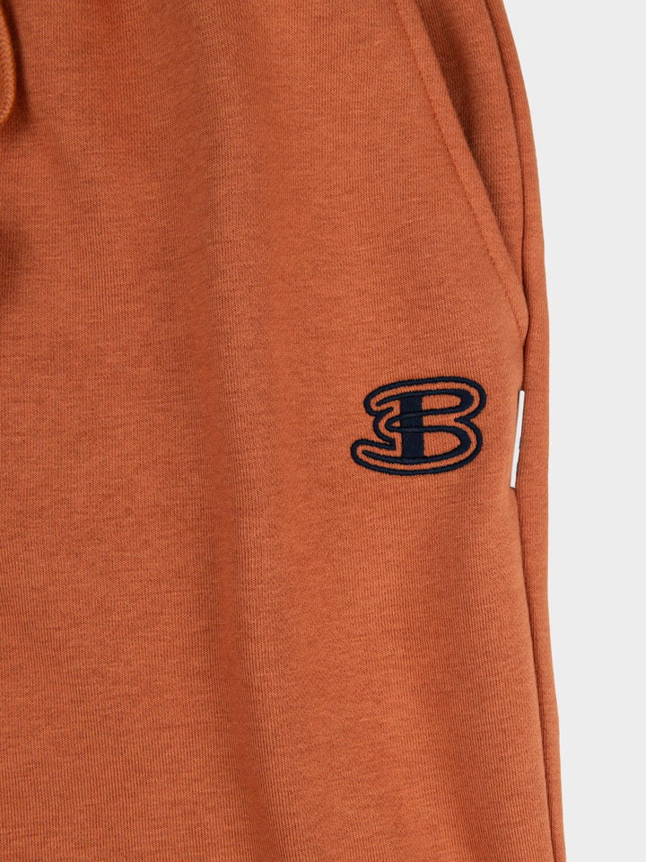 Close-up of embroidered Ben Sherman logo on brown fleece jogger shorts - premium quality fabric detail
