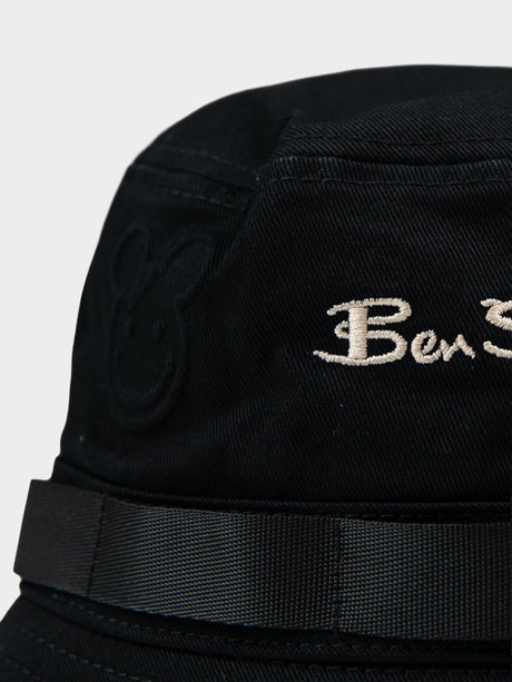 Close-up of Ben Sherman embroidered logo and bear motif emboss detail on black bucket hat