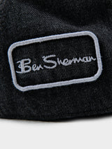 Close-up of Ben Sherman embroidered logo patch on black denim Dixie Cap