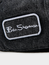 Close-up of Ben Sherman embroidered logo patch on charcoal denim Dixie Cap