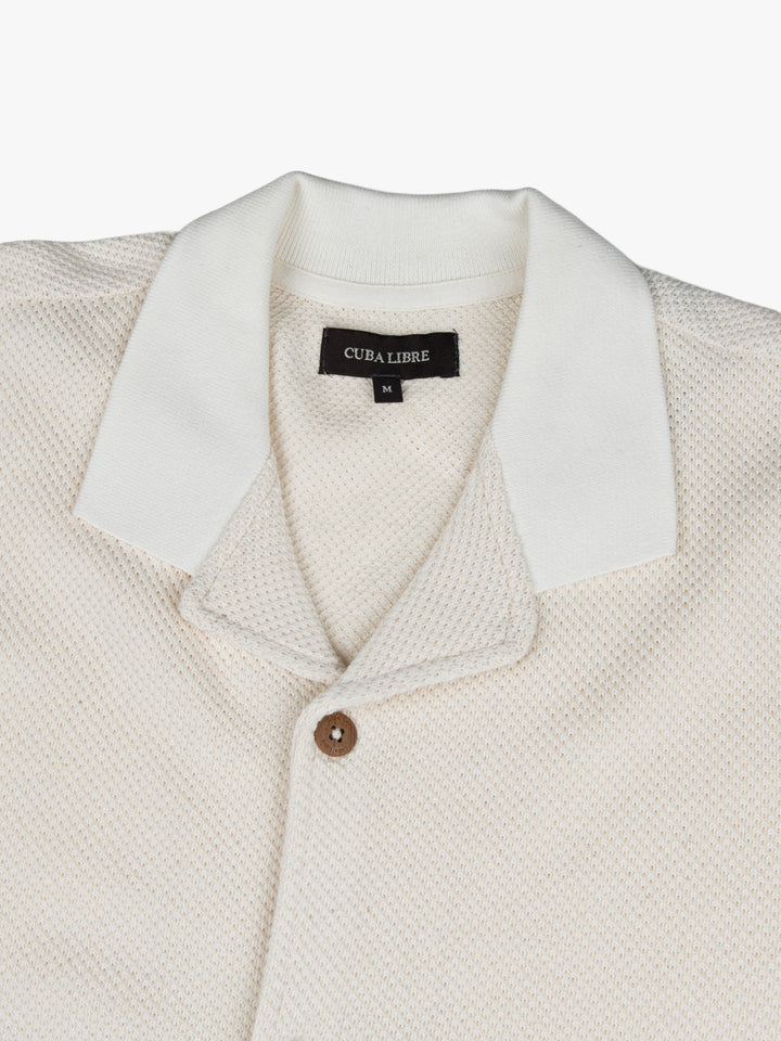 Close-up of the collar and button detail on the Cuba Libre Bastion Knit Shirt in Cream by Partisan and Co