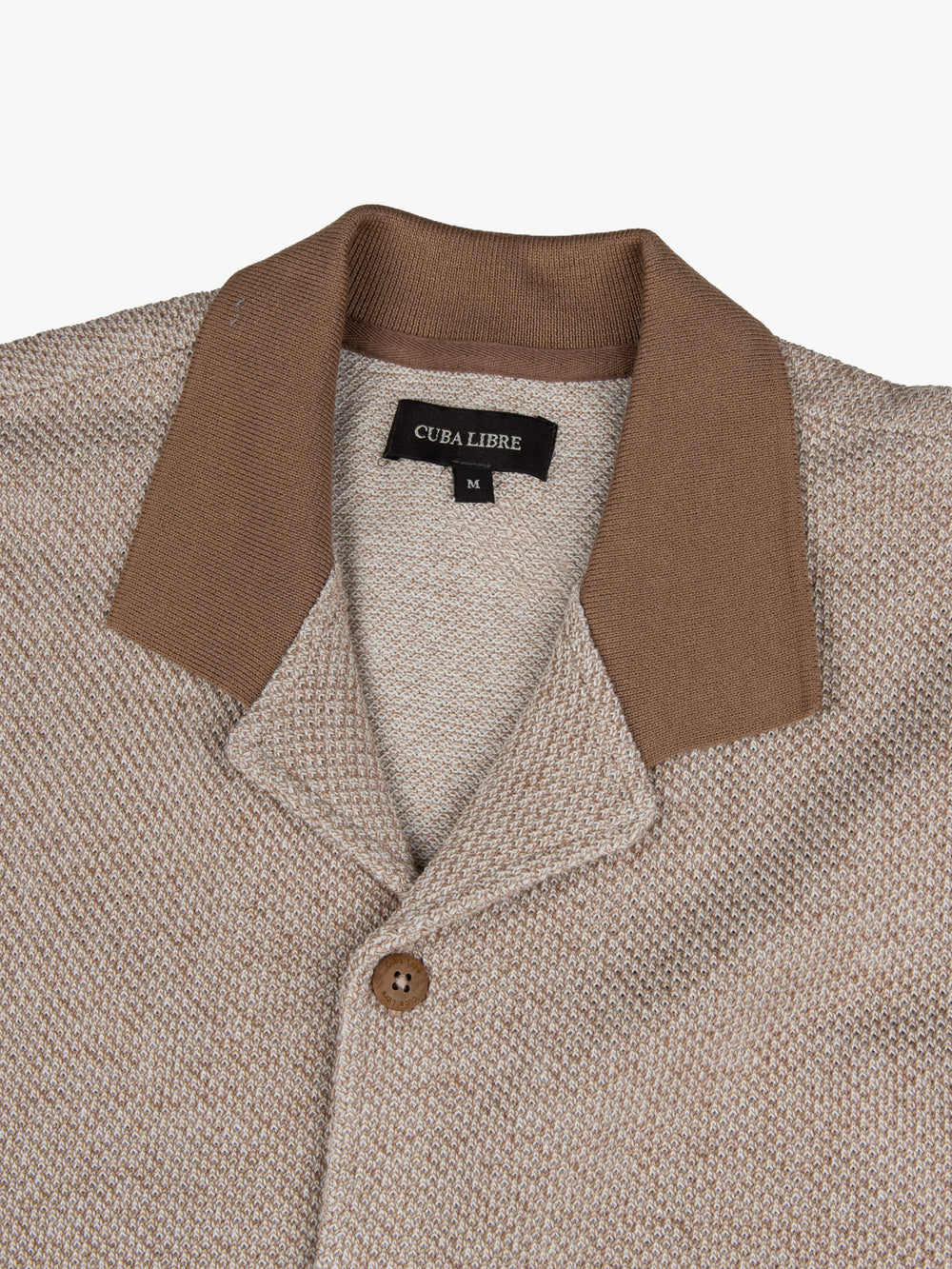 Close-up of the contrast collar and button detail on the Cuba Libre Bastion Knit Shirt in Tobacco by Partisan and Co