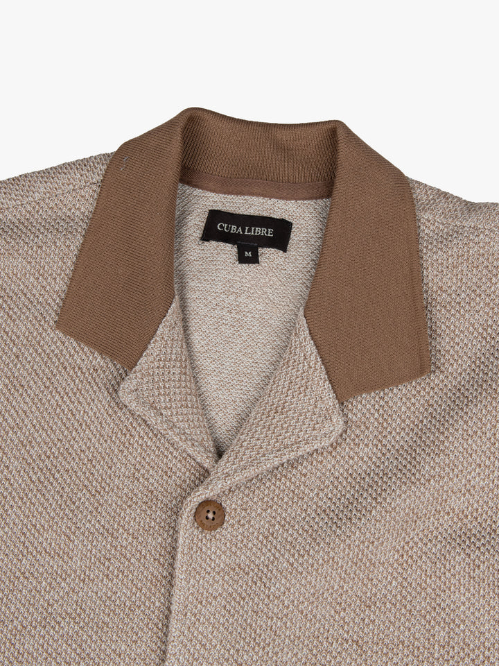 Close-up of the contrast collar and button detail on the Cuba Libre Bastion Knit Shirt in Tobacco by Partisan and Co
