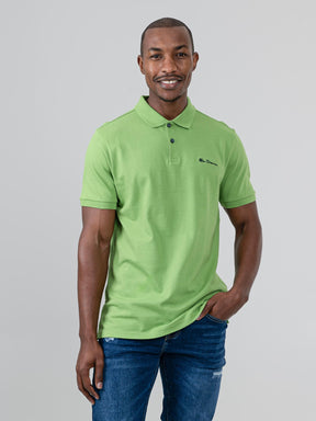 Ben Sherman Ben Polo in Piquant Green - model wearing front view showing embroidered script chest logo and two-button placket