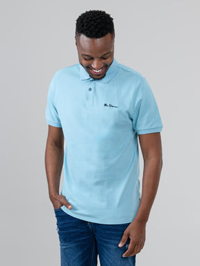 Ben Sherman Ben Polo in Retro Blue - model wearing front view showing embroidered script chest logo and two-button placket