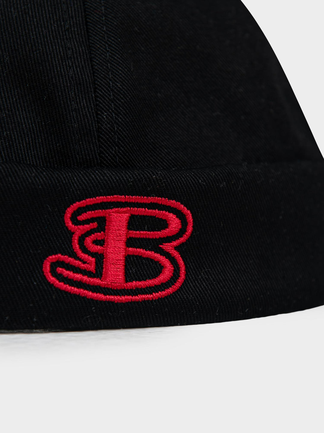 Ben Sherman Docker Hat Black — close-up of red embroidered B logo detail on cuffed cotton brim