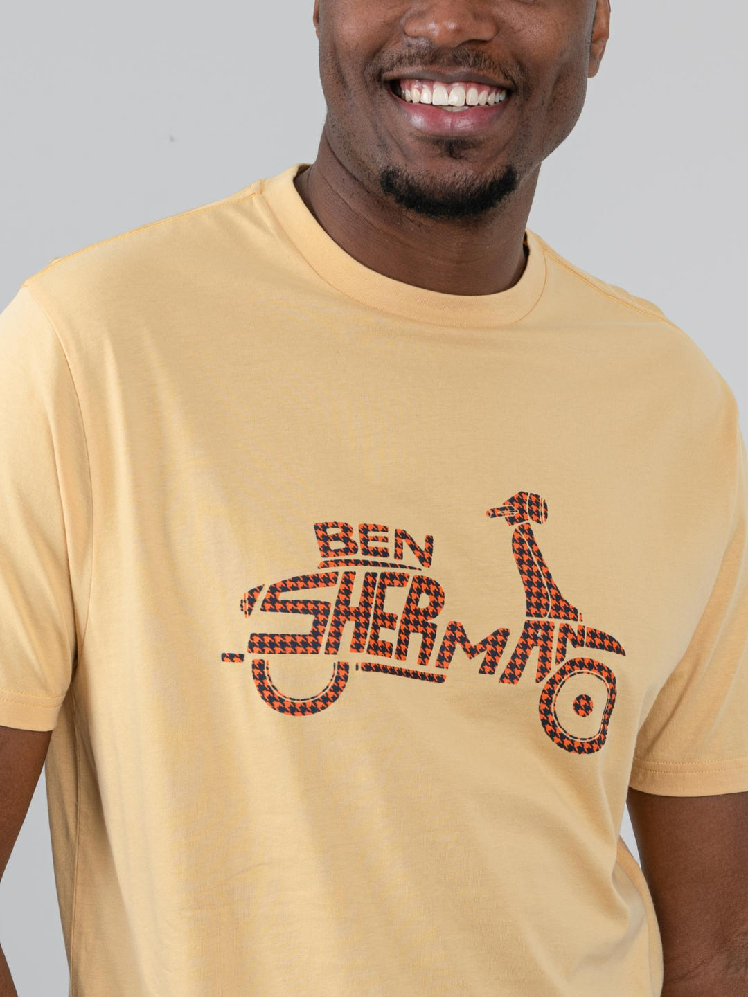 Ben Sherman Brand Scooter Tee in New Wheat - close-up of iconic scooter graphic print with signature checkered tartan detail on wheat yellow fabric