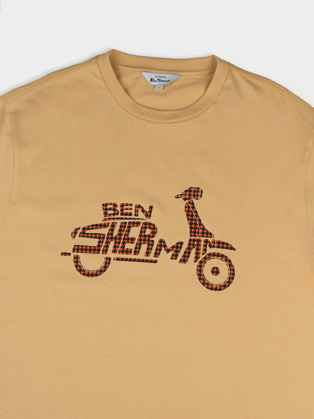 Ben Sherman Brand Scooter Tee in New Wheat - close-up of crew neckline, branded label and bold checkered scooter graphic on wheat yellow fabric