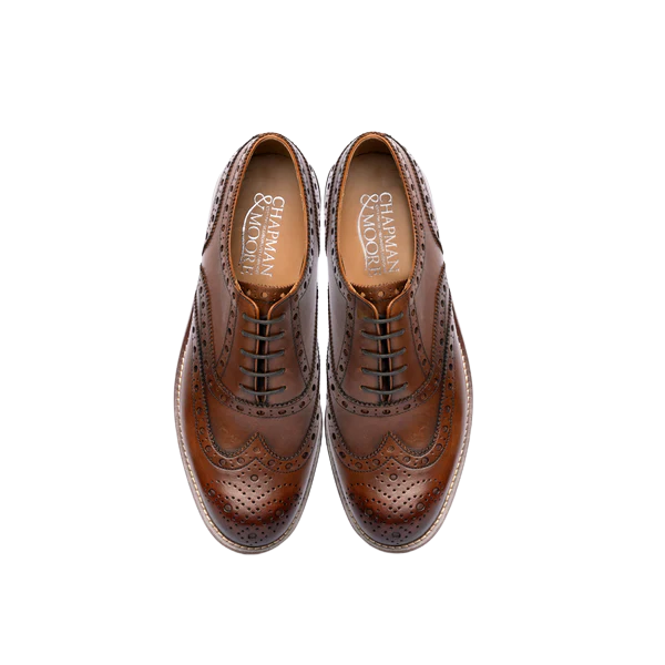 Chapman &amp; Moore chocolate leather brogues top-down pair view, showing branded insoles, brogue perforations and waxed cotton laces