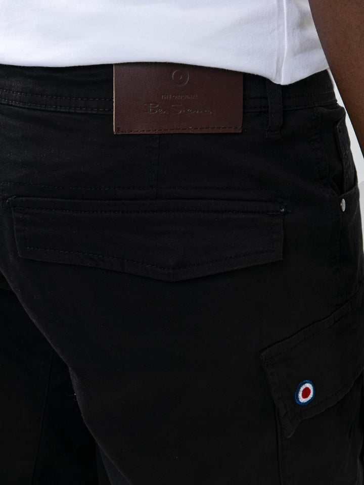 Back detail of Ben Sherman black cargo pants showing leather branding label and target logo