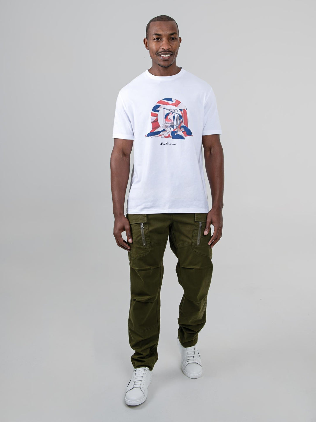 Model wearing Ben Sherman olive cargo pants styled with a white graphic tee - full outfit look