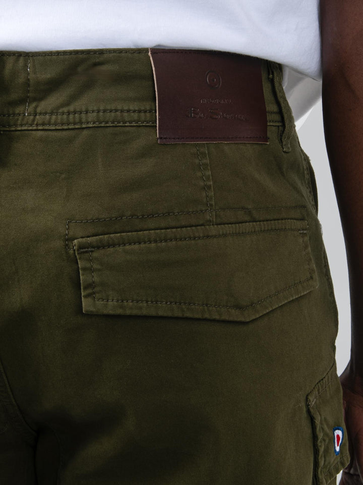 Back detail of Ben Sherman olive cargo pants showing leather branding label on back pocket