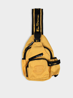 Ben Sherman Chestpack Satchel in Banana Yellow — front view showing embossed B logo, zip compartments and black branded strap