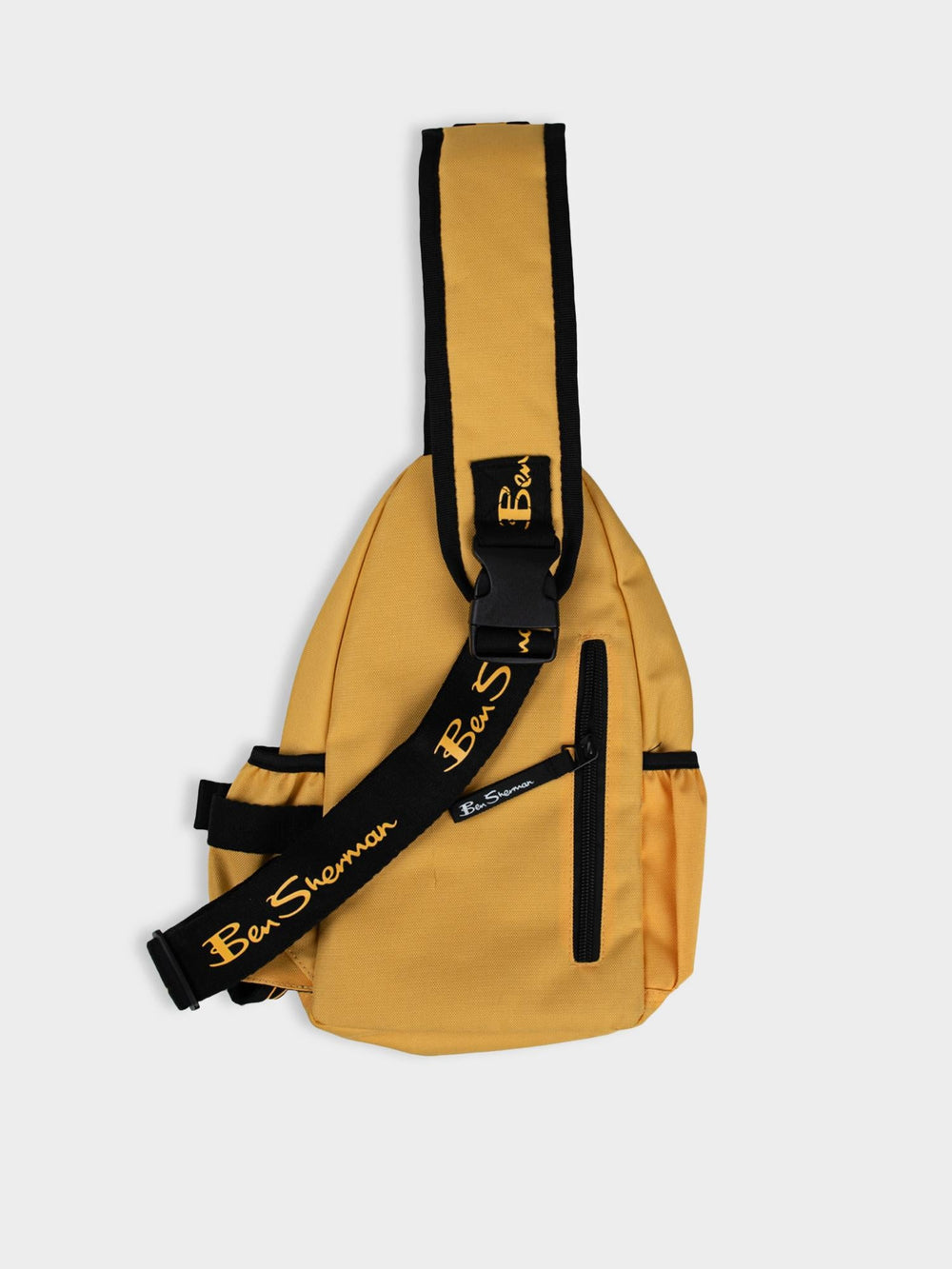 Ben Sherman Chestpack Satchel in Banana Yellow — side view highlighting adjustable shoulder strap with branded logo detail