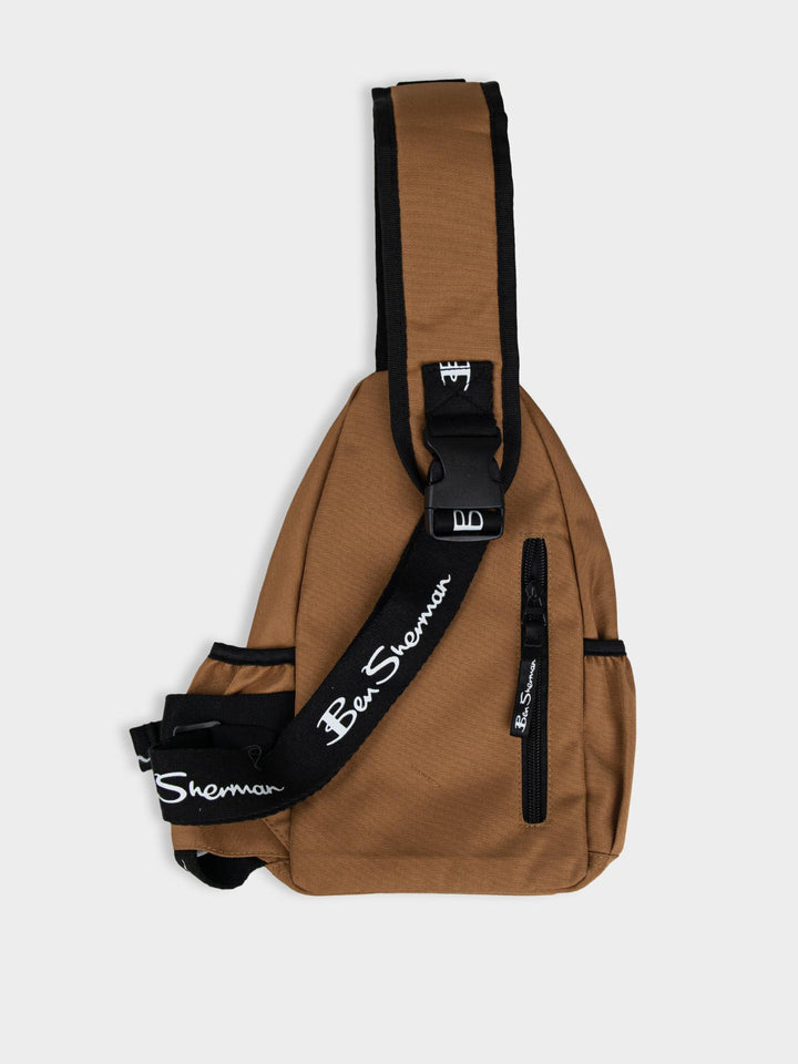 Ben Sherman Chestpack Satchel in Medal Bronze — side view highlighting branded strap, embossed B logo detail and structured silhouette