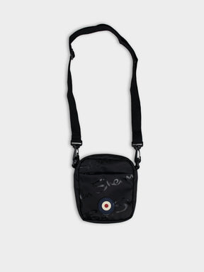 Ben Sherman Compact Crossbody Wax Plastisol Bag in Black with adjustable strap and Mod target emblem – front view