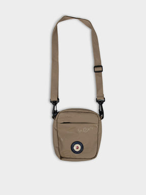 Ben Sherman Compact Crossbody Wax Plastisol Bag in Stone with adjustable strap and Mod target emblem – front view