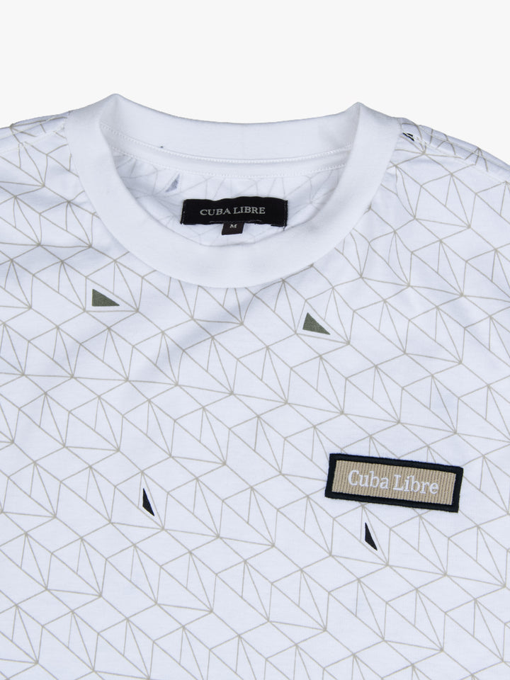 Close-up of Cuba Libre Tee in White Geo showing all-over geometric print detail and woven logo patch at chest
