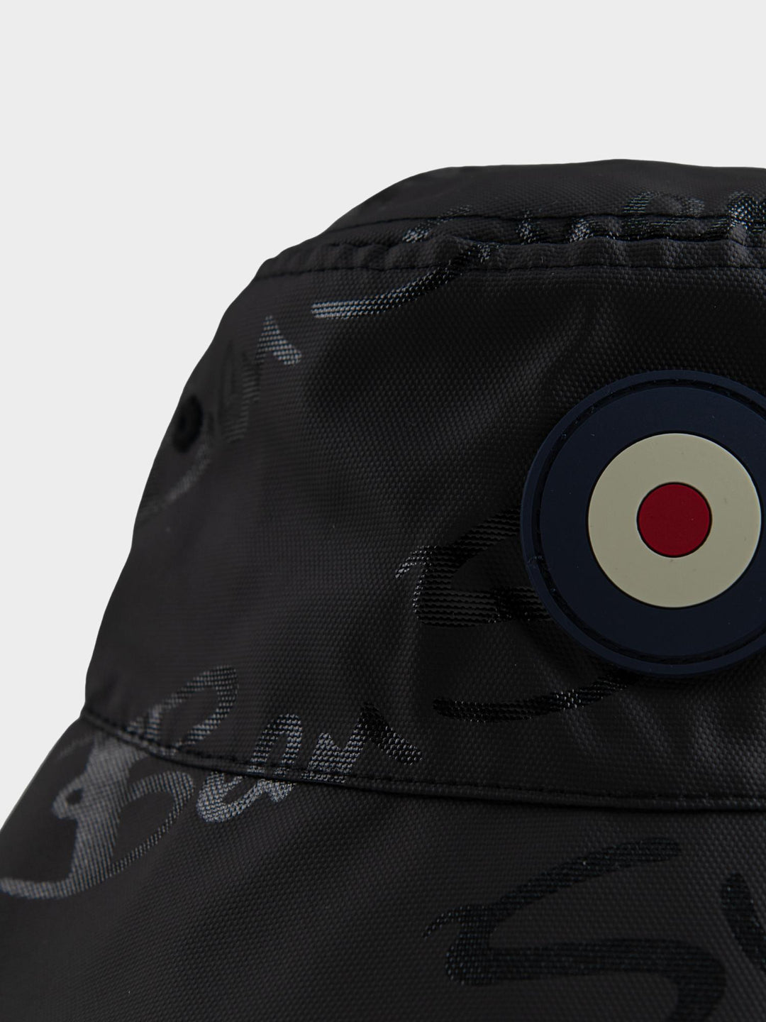Ben Sherman bucket hat in Black – close-up of embroidered target logo on the reversible interior lining