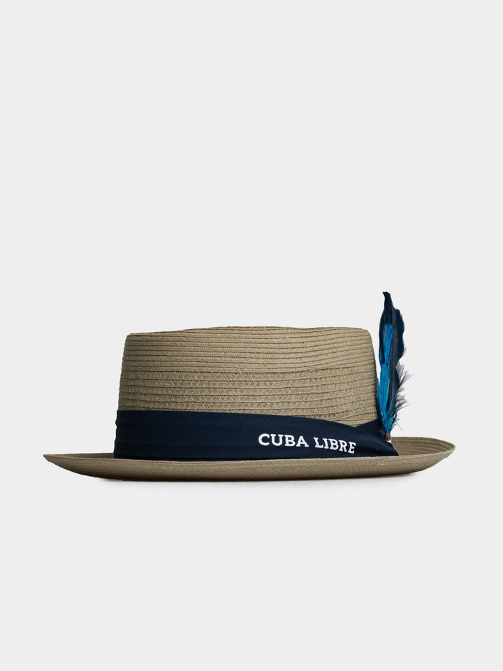Cuba Libre Pork Pie Hat in Beige - lightweight woven straw, flat crown, narrow brim, navy band and feather accent