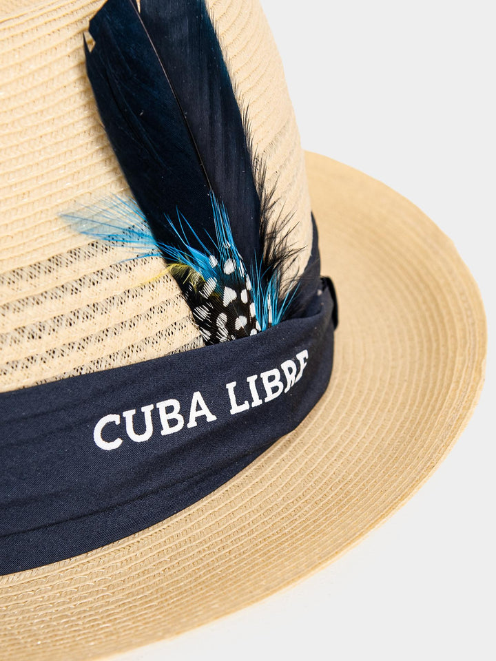 Close-up of Cuba Libre Fedora Straw Hat Natural - navy band with embroidered Cuba Libre logo and feather trim detail