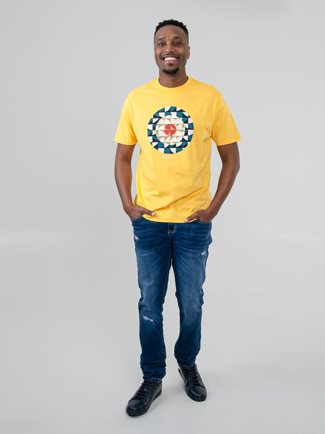 Man wearing Ben Sherman Geo Target T-Shirt in Banana yellow — full-length front view with geometric print