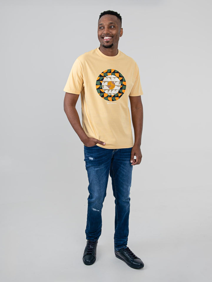 Man wearing Ben Sherman Geo Target T-Shirt in New Wheat — full-length front view with geometric print