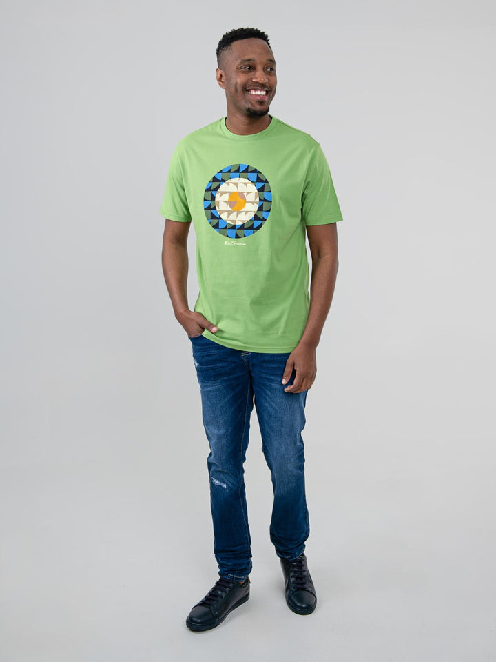 Man wearing Ben Sherman Geo Target T-Shirt in Piquant Green — full-length front view with geometric print