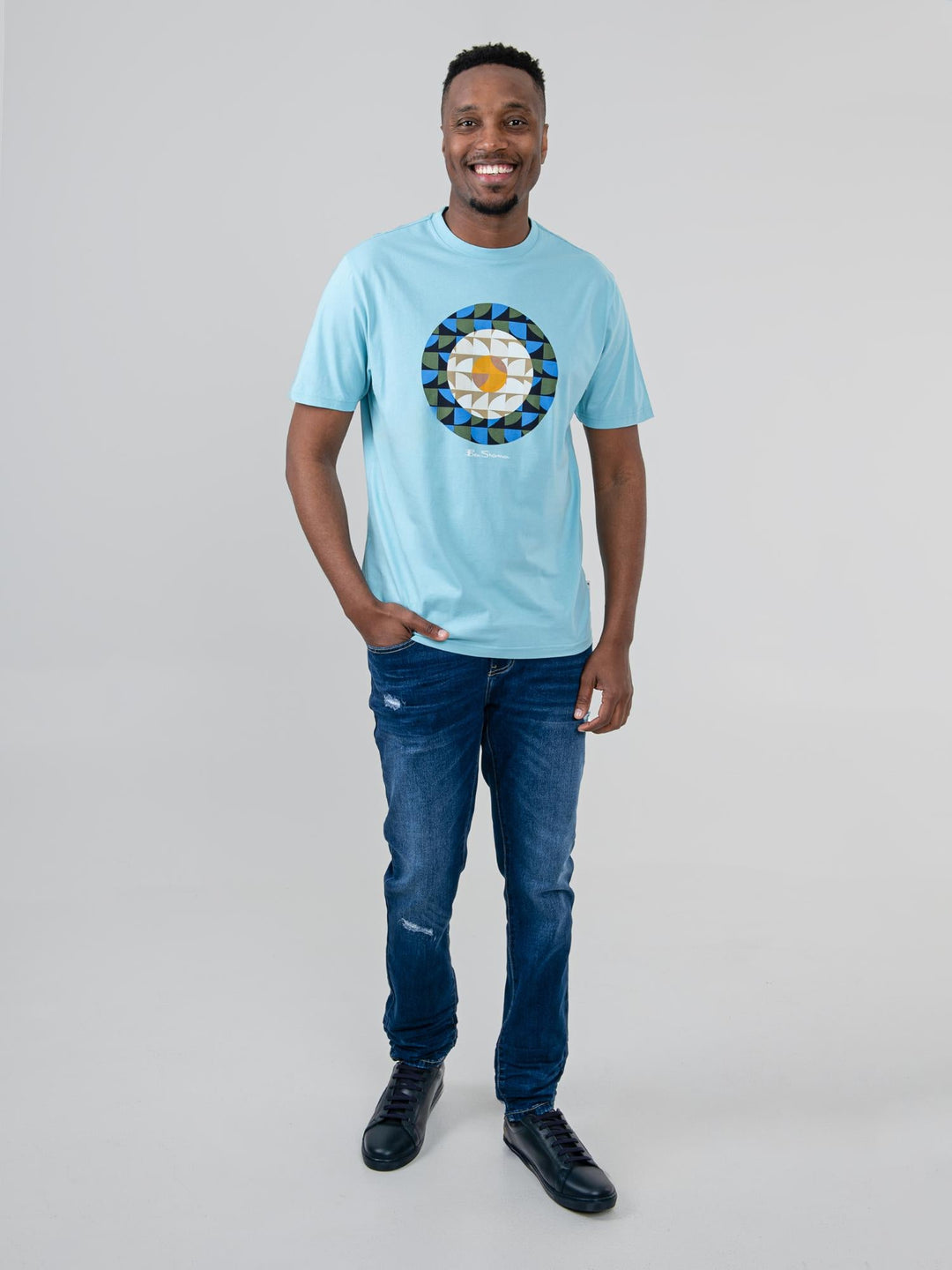 Man wearing Ben Sherman Geo Target T-Shirt in Retro Blue — full-length front view with geometric print