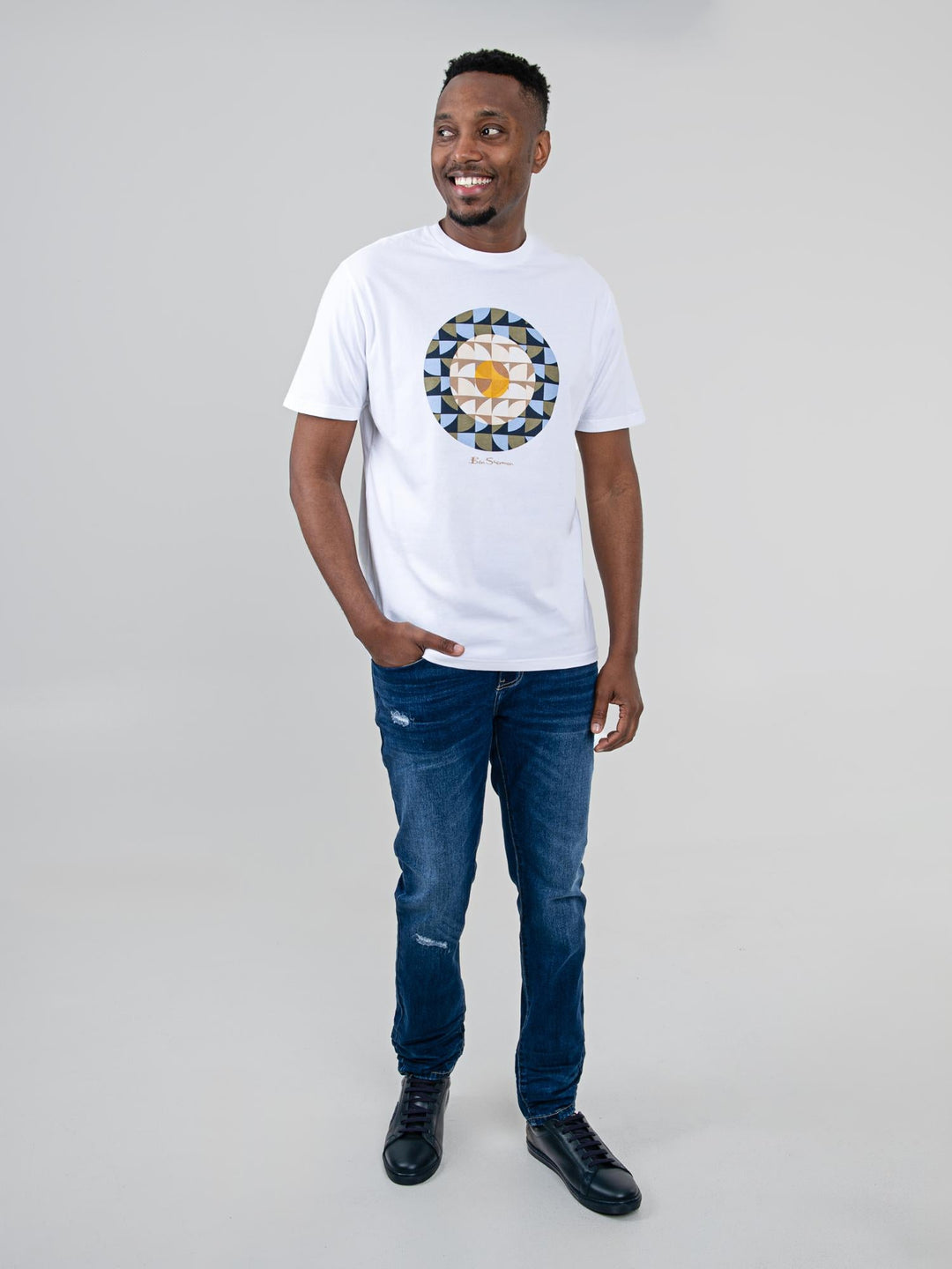 Man wearing Ben Sherman Geo Target T-Shirt in White — full-length front view with geometric print