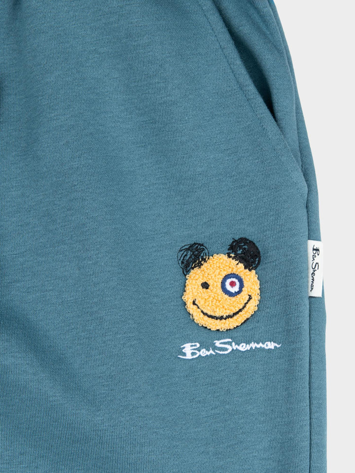 Close-up of embroidered Happy Bear motif and Ben Sherman logo on Greek Blue fleece jog shorts