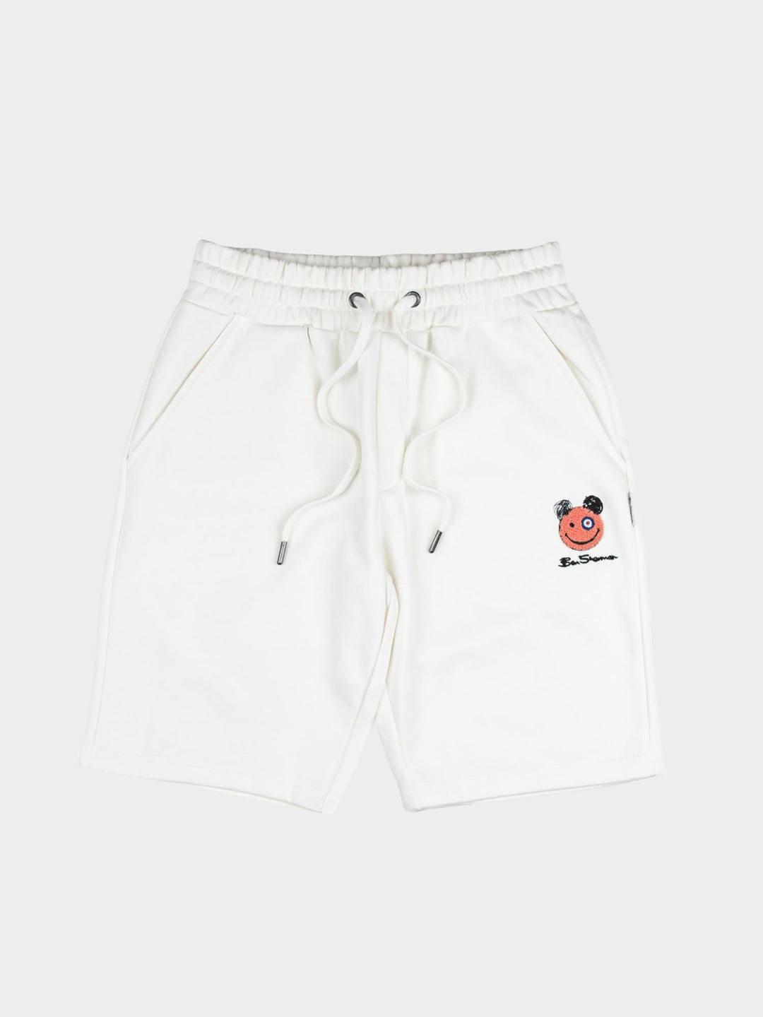 Close-up of embroidered Happy Bear motif and Ben Sherman logo on off-white fleece jog shorts