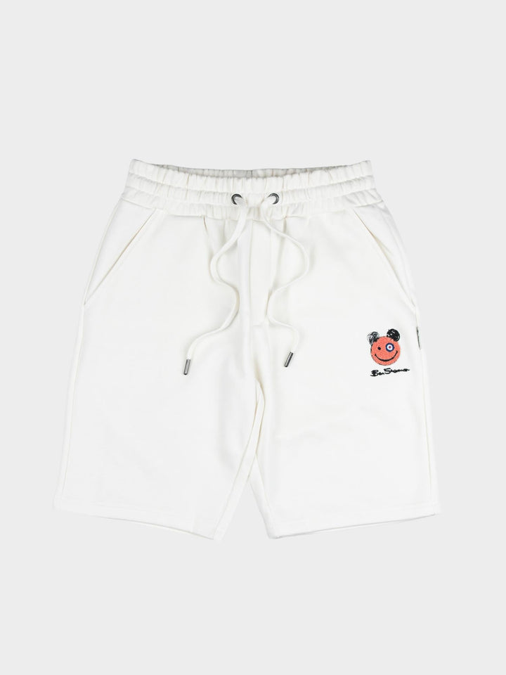 Close-up of embroidered Happy Bear motif and Ben Sherman logo on off-white fleece jog shorts
