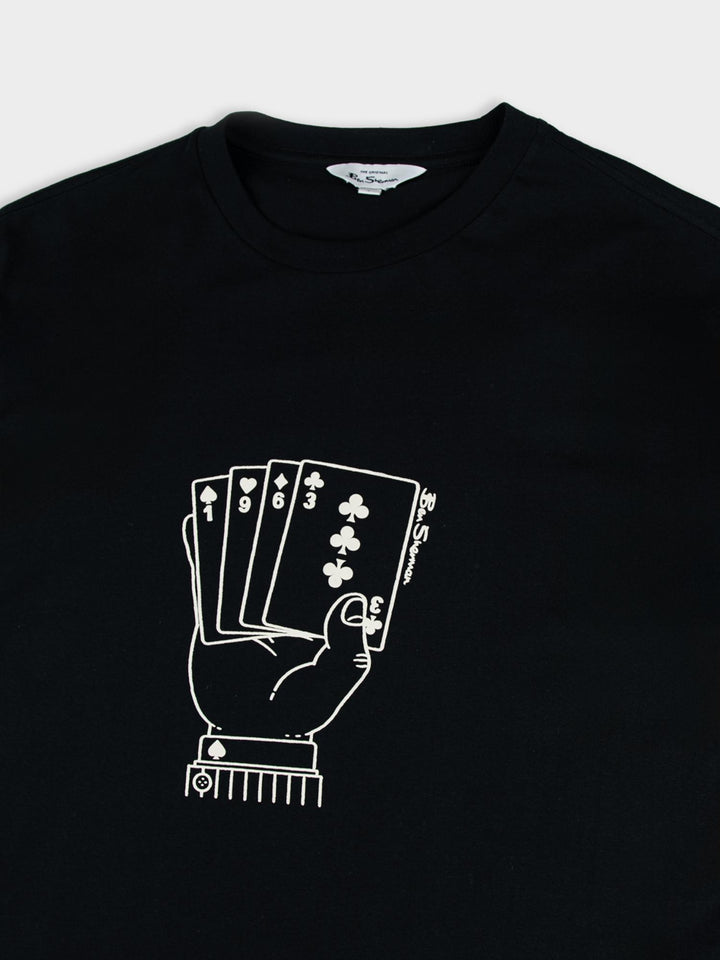 Detail shot of Ben Sherman Hidden Ace T-Shirt graphic – hand holding playing cards print on black cotton, showcasing the monochrome artwork
