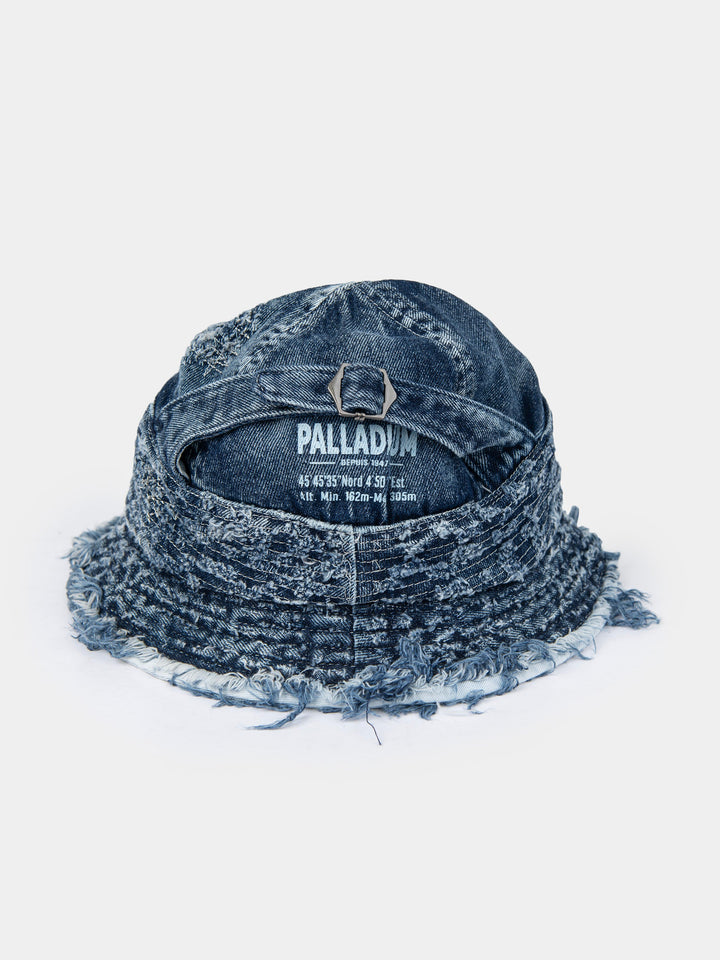 Palladium frayed bucket hat in navy washed denim with raw frayed brim and Palladium branding