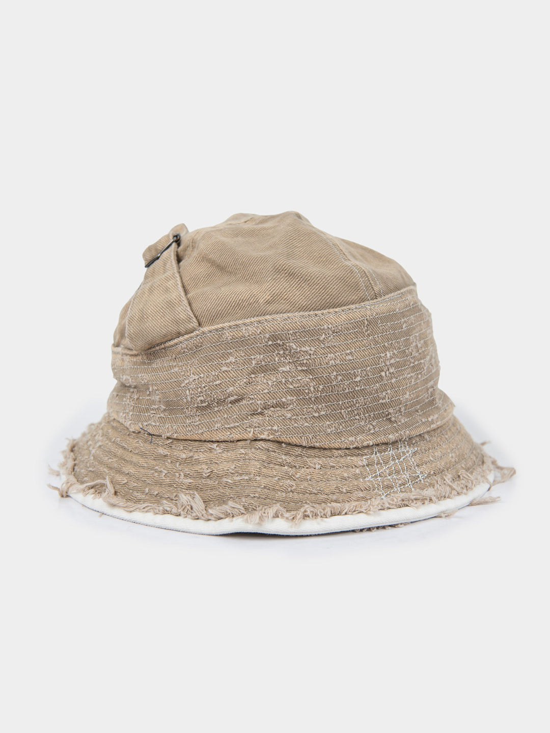 Side view of the stone Palladium frayed bucket hat in washed canvas with a frayed, distressed brim