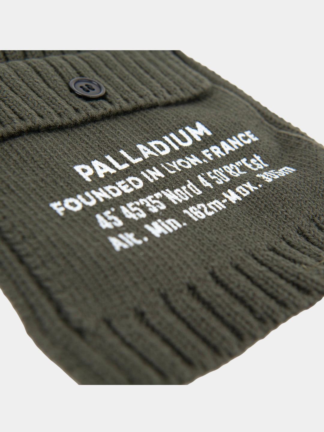 Close-up of the olive Palladium Cargo beanie showing embroidered Palladium branding and button-detail side pocket