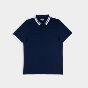 Partisan 2017 Polo in Sprink Navy — contrast collar, woven branding and embossed chest emblem on dark navy piqué